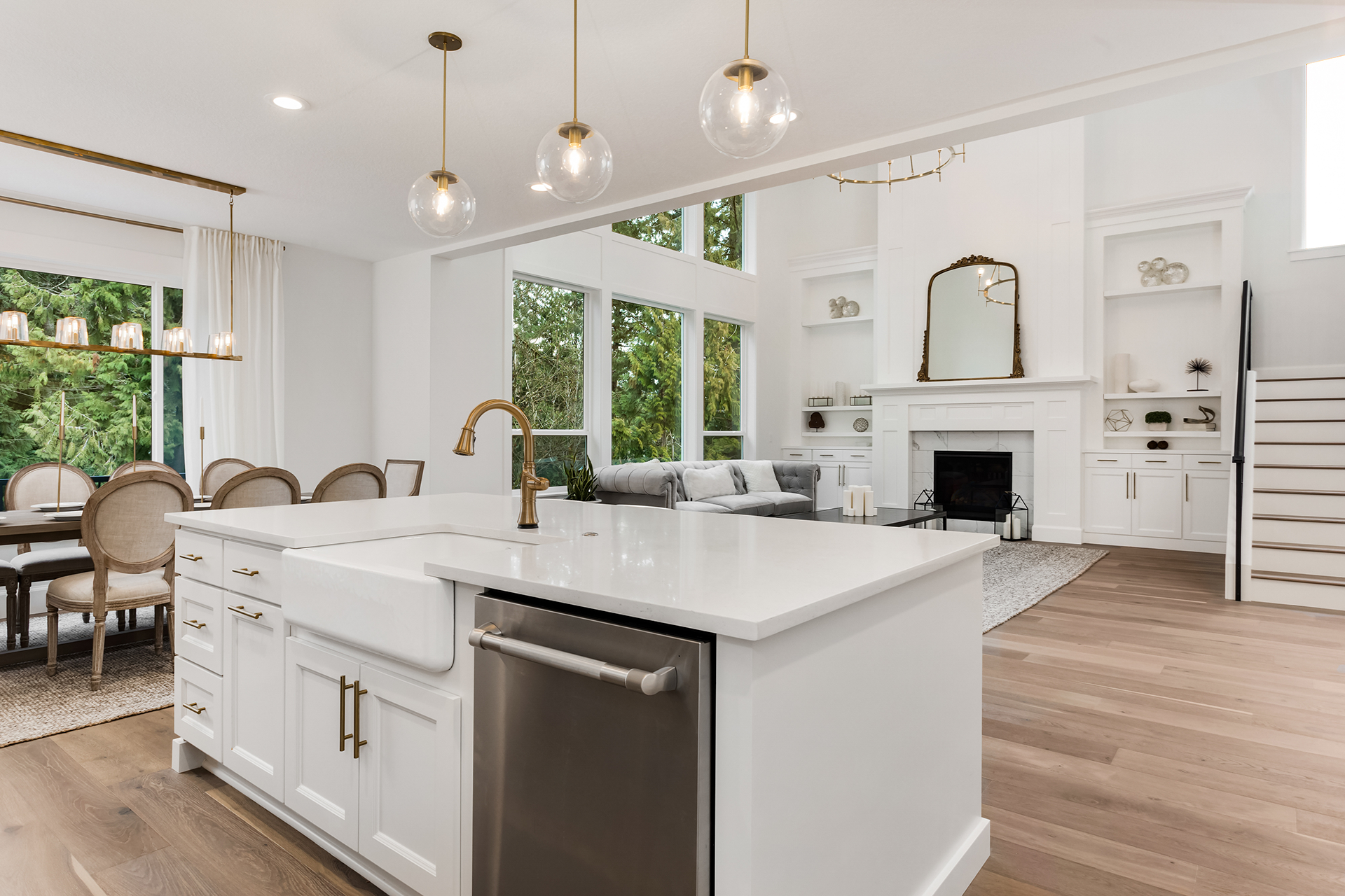Kitchen island with sink overlooking dining and living room