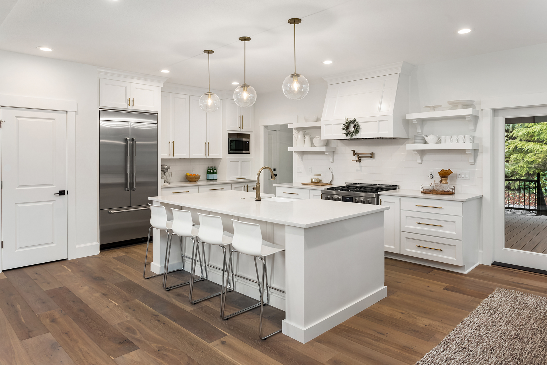 Open kitchen layout with stainless appliances and open shelving